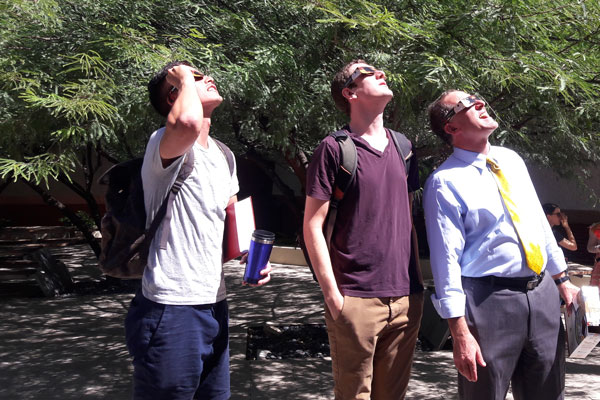 Dean Miller watching the solar eclipse with students
